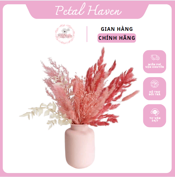 a pink vase with dried flowers